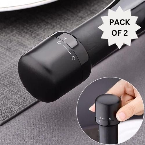 Premium silicone wine and champagne bottle stoppers, pack of 2 black caps for sealing bottles on tabletop surface.