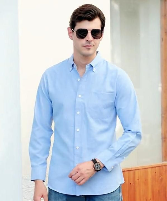 Stylish casual men's long-sleeved blue button-up shirt with sunglasses and watch